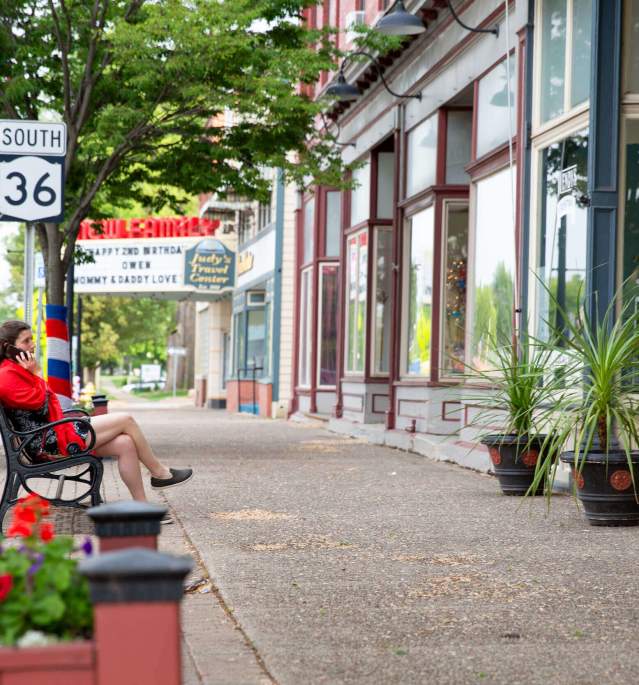 Woman sitting on bench talking on the phone