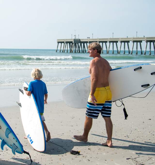 Family surfing on Wrightsville Beach