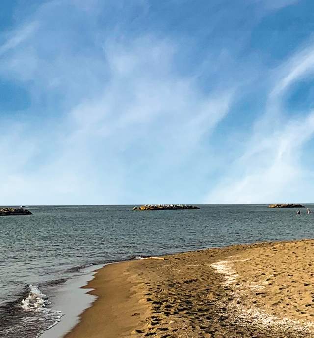 Man seen on the shoreline of Lake Erie on a sunny day