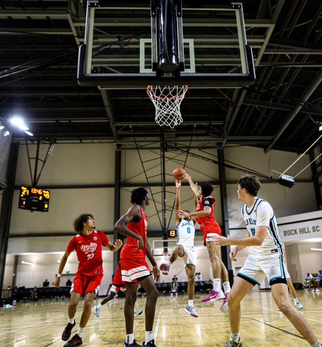 Basketball game young man takes a fadeaway shot
