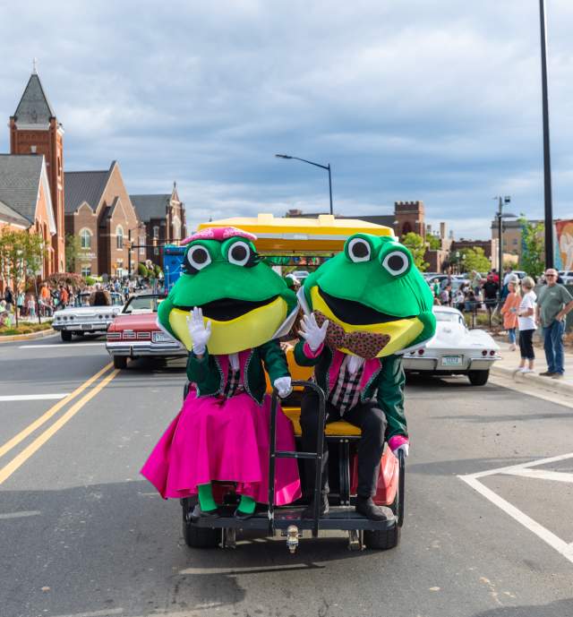 Two frog mascots for Come See Me Parade