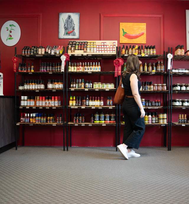 Woman strolling selections of hot sauce