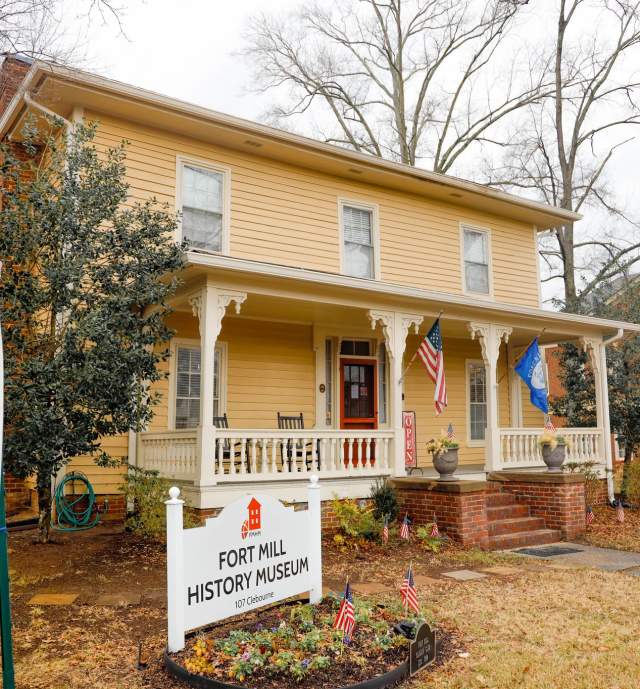 Yellow house and a sign in front of it reading Fort Mill History Museum