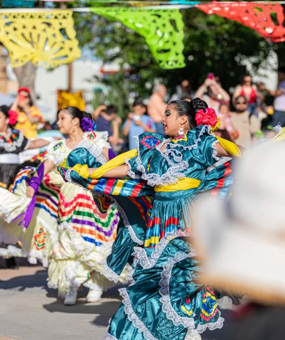 Photo of women in traditional Jalisco Ribbon Dresses dancing at Pat Coursey Park during Cinco De Mayo Celebration in 2025.