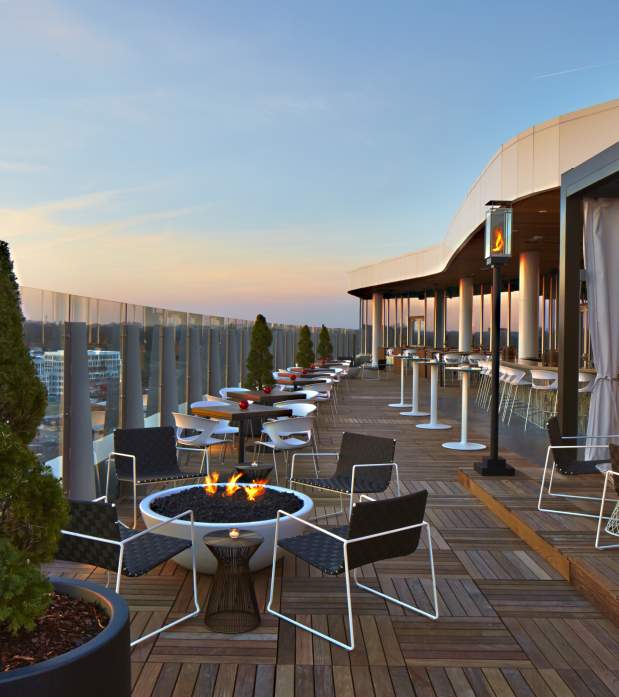 The view from eight stories up on the patio at VASO Rooftop Lounge with seating and firepits.