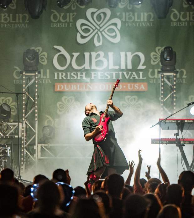 Guitarist from the Red Hot Chili Pipers performing on stage at the Dublin Irish Festival