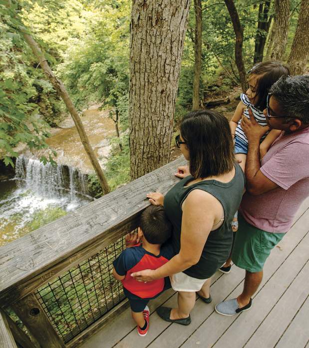 Family looking over the observation deck down to Indian Run waterfall