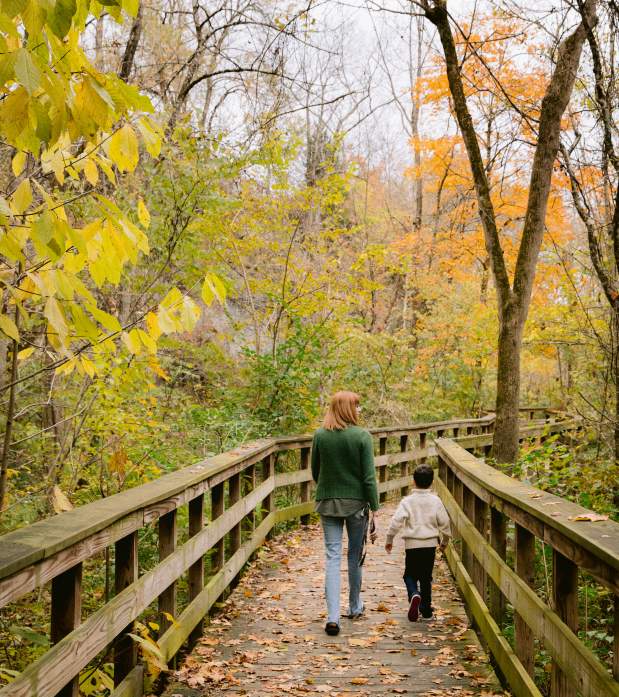 Mother and son walking the observation deck at Hayden Run Falls surrounded by fall color.