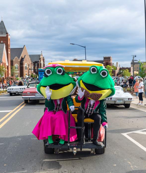 Two frog mascots for Come See Me Parade