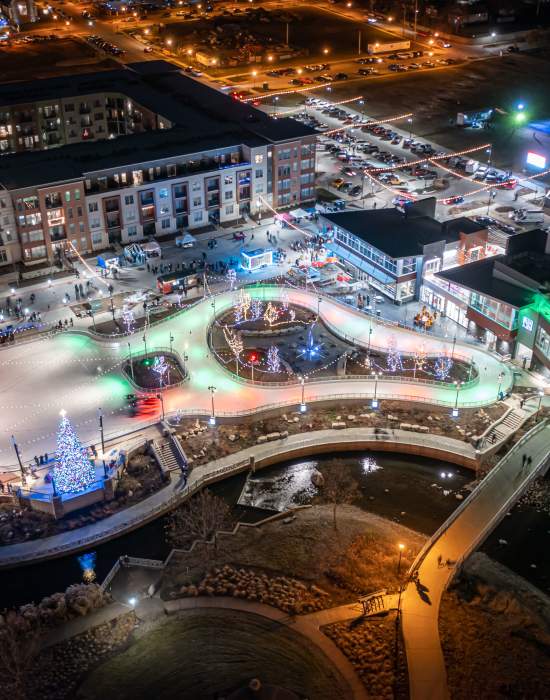 Aerial shot of Mishawaka Ironworks ice skating facility at night with holiday lights