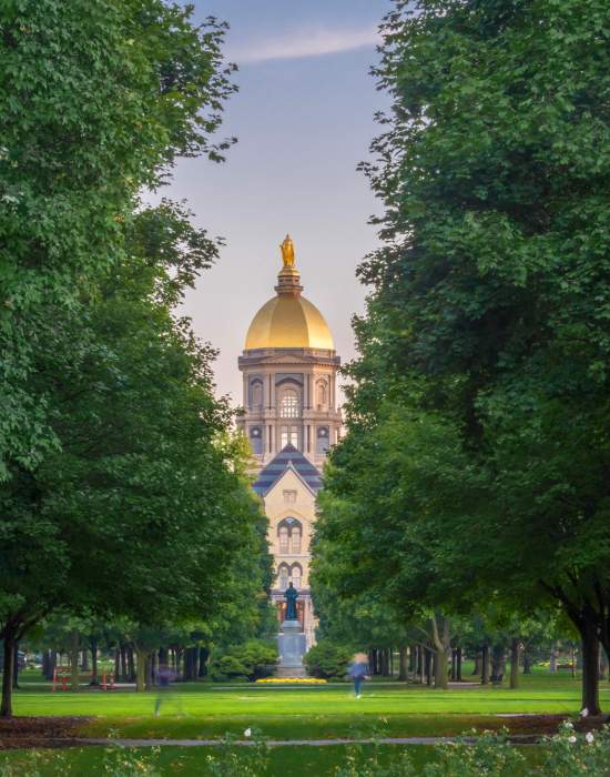 Students walking to class with the Golden Dome in the background