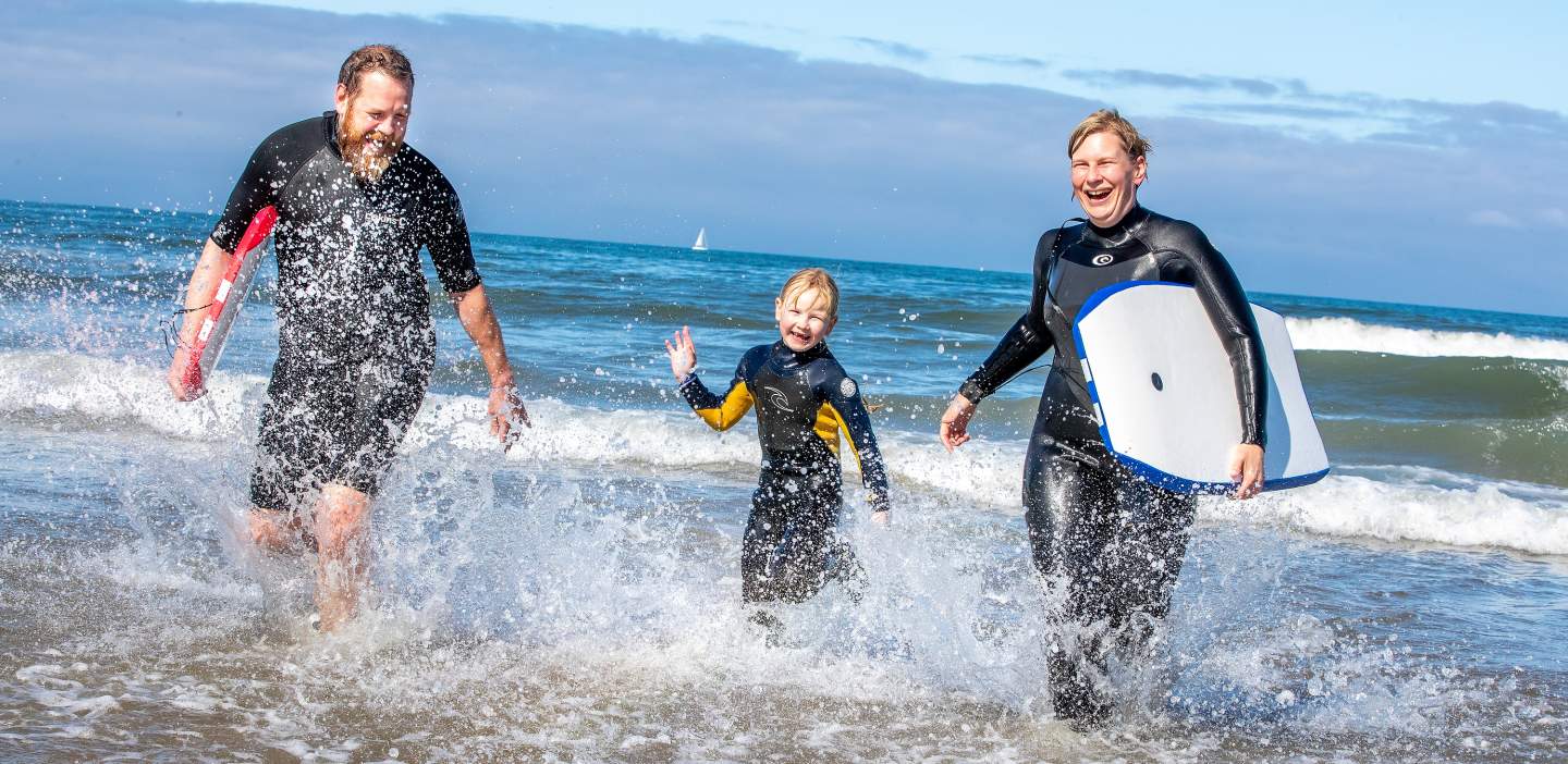 An image of a family enjoying surfing on the Yorkshire coast