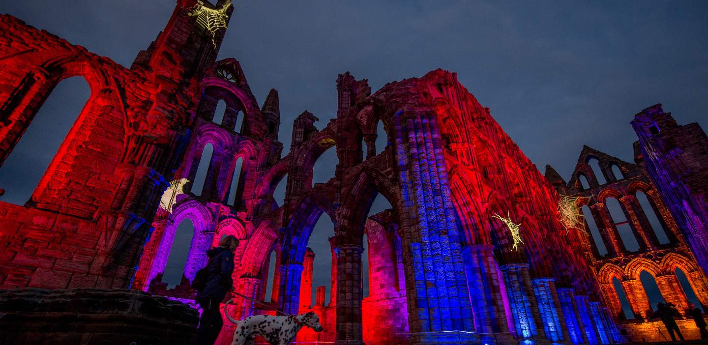 An image of illuminated Whitby Abbey on Halloween
