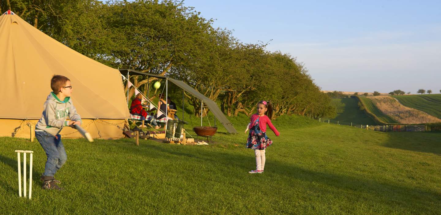 An image of children playing at a campsite