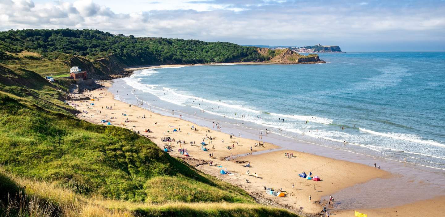 An image of Cayton Bay beach in the summer