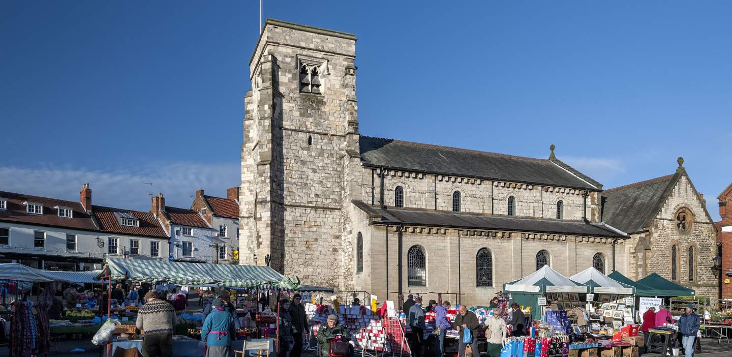 Malton Market packed with stalls and shoppers in the shadow of the town hall