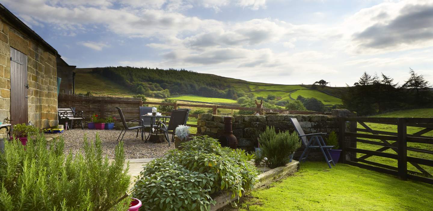 An image of a garden overlooking the hills at a self catering accommodation property
