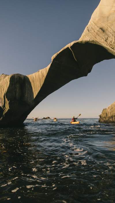 Kayakers paddling through Dinosaur Caves in San Luis Obispo