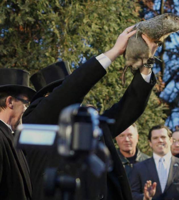 Man holding up a groundhog / groundhog day