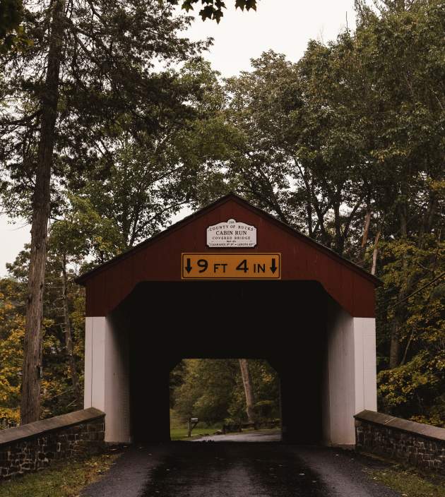 A moody, historic covered bridge in the fall