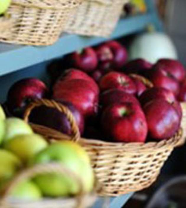 Green and red apples in baskets