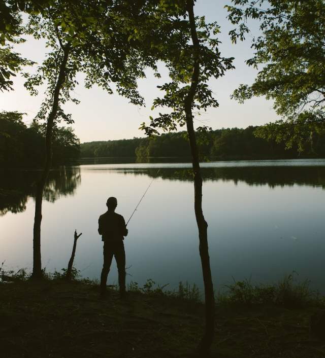 A fisherman casting at Lake Craig at Croft State Park