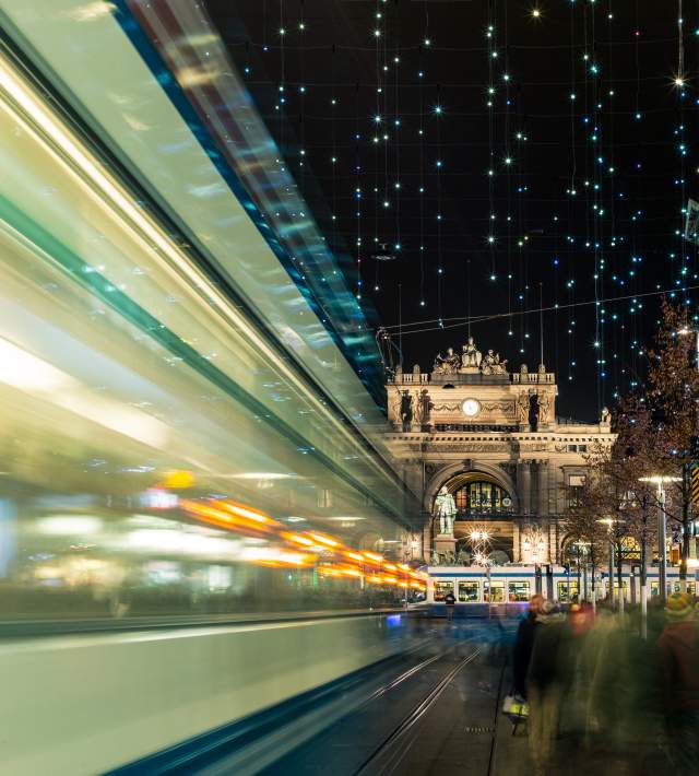 View of a street in Zurich at night with blurred lights of cars