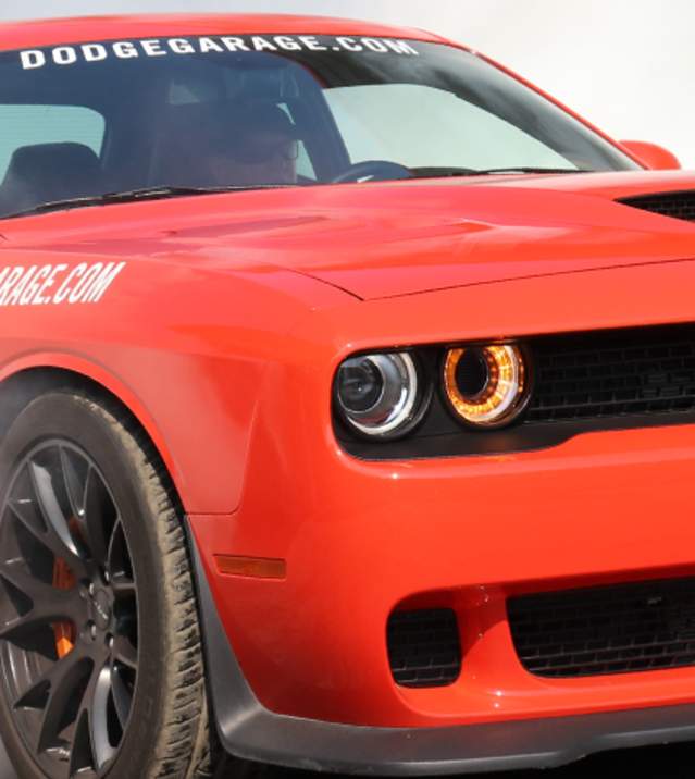 A Dodge spins its tires are the start of a race at Carlisle Chrysler Nationals