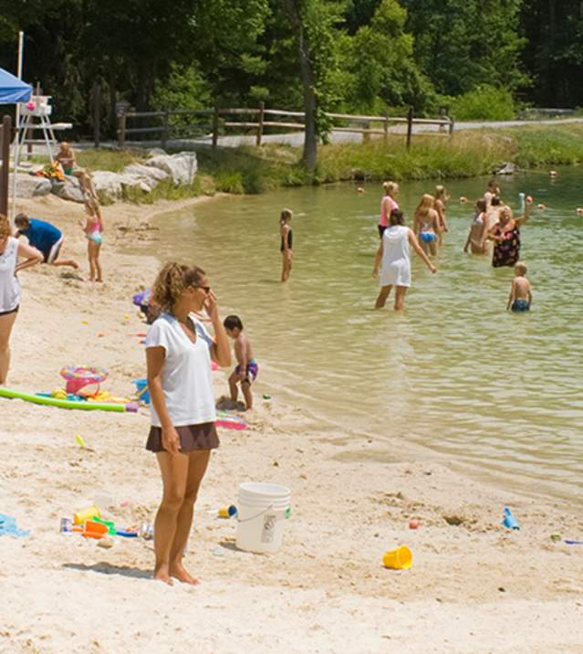 Swimmers at Fuller Lake beach in Pine Grove Furnace State Park.