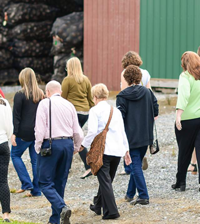 Tour group at Meadwbrooke Gourds touring harvested gourds facility
