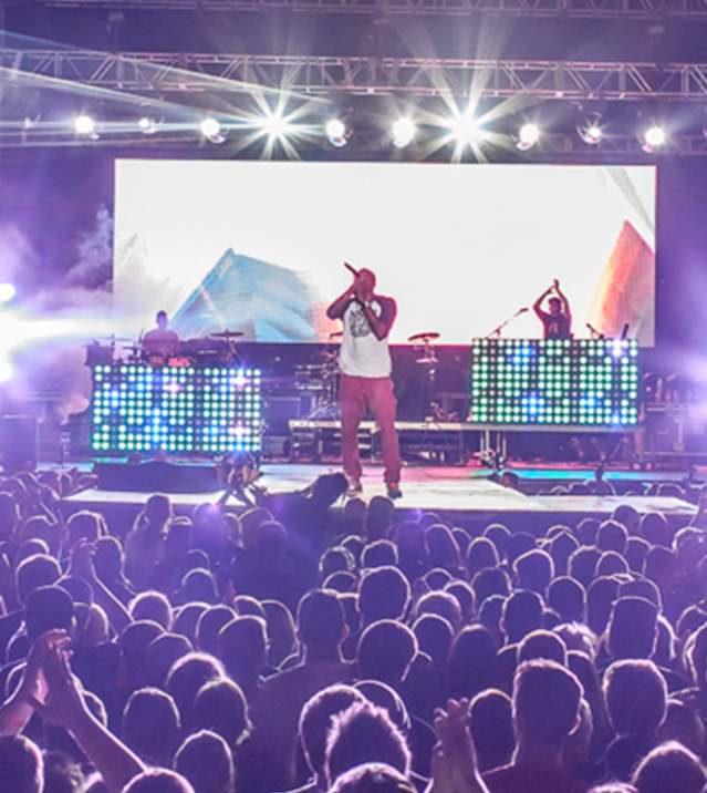 Crowd surrounding the stage at night during the Uprise Festival