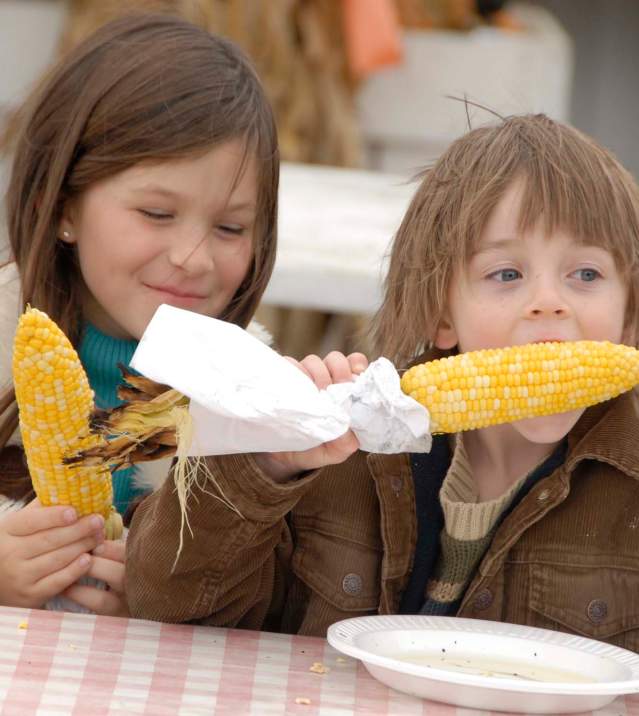 Kids eating corn