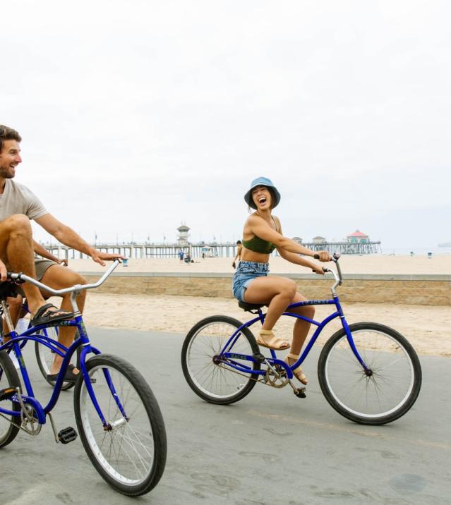 Bike Riding at Huntington Beach | Couple enjoying bike riding on the Huntington Beach Strand