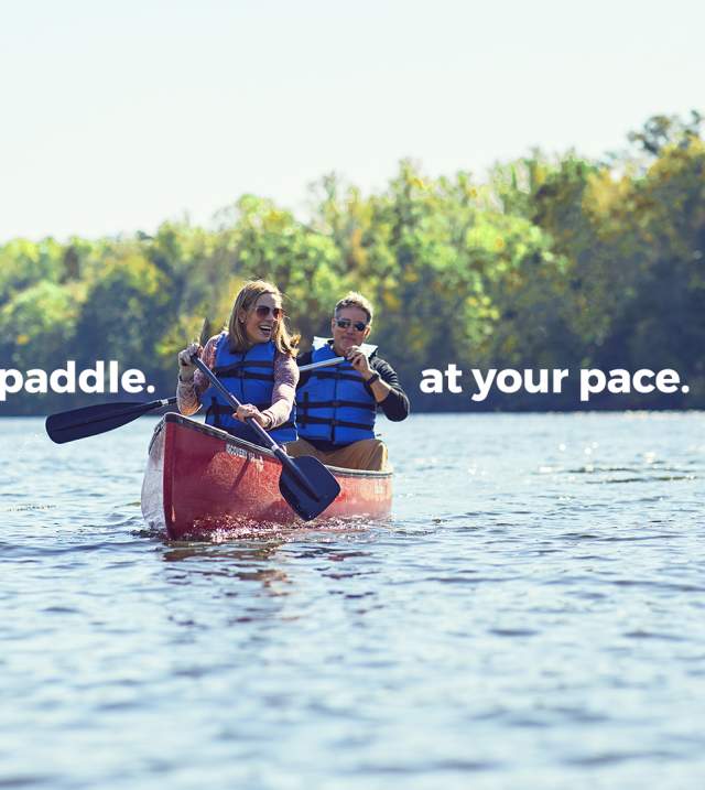 Paddle. At your pace. Couple canoeing outdoors