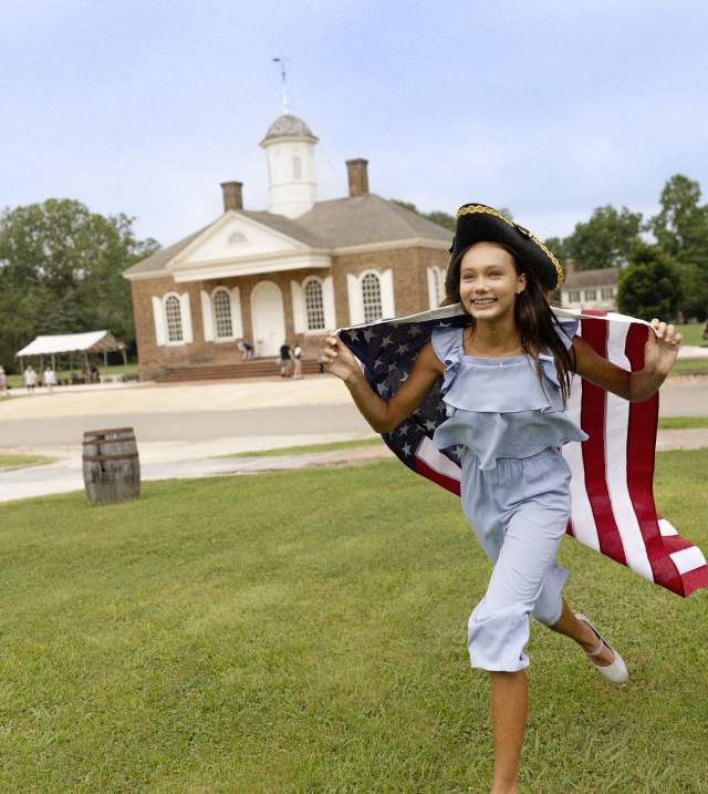 Girl with American Flag Running around Colonial Williamsburg