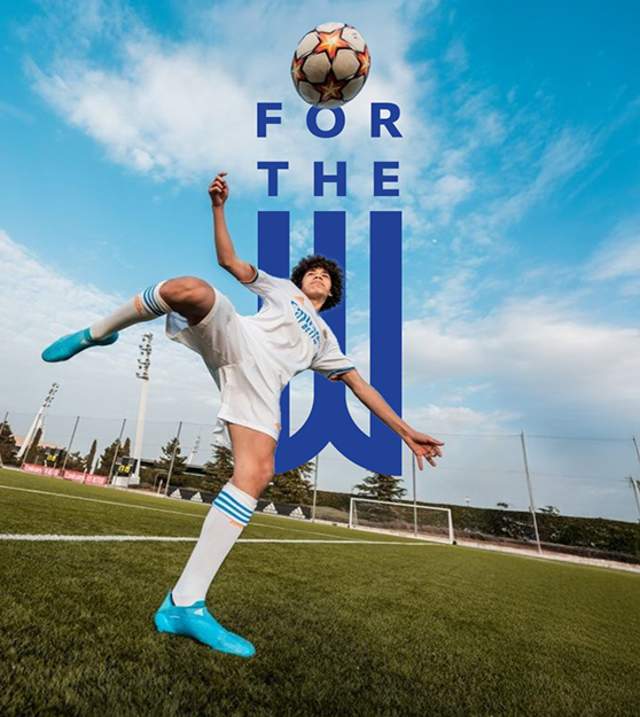 For the W! Boy kicking a soccer ball in the air