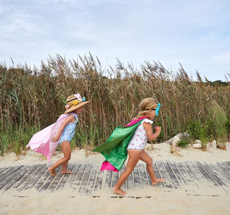 2 girls running on the beach