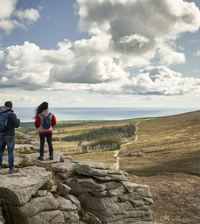 Walkers enjoying a spectacular view of The Mourne Mountains and Silent Valley as part of the Men of the Mournes Embrace a Giant Spirit experience.