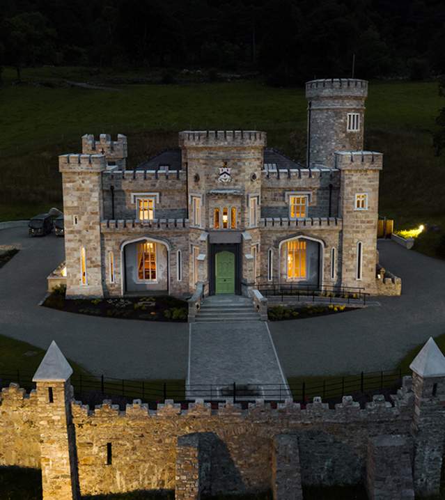 Exterior of Killeavy Castle Hotel lit up in the early evening light