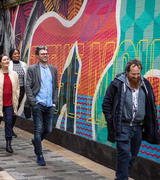 Group enjoying a street art walking tour with Seedhead Arts