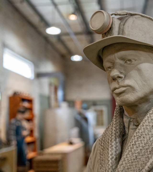 Sculpture of a miner and the No. 9 Mine Museum