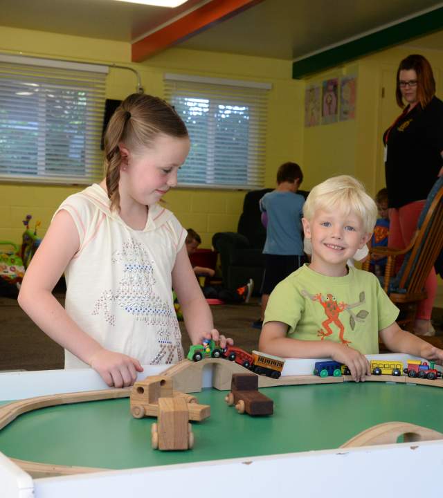 Children play with a wooden trail at the indoor play area at the Utah Shakespeare Festival Childcare facility.