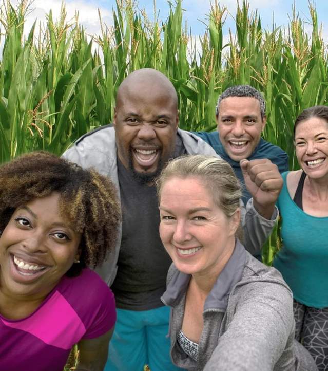 group of 5 adults in a corn maze