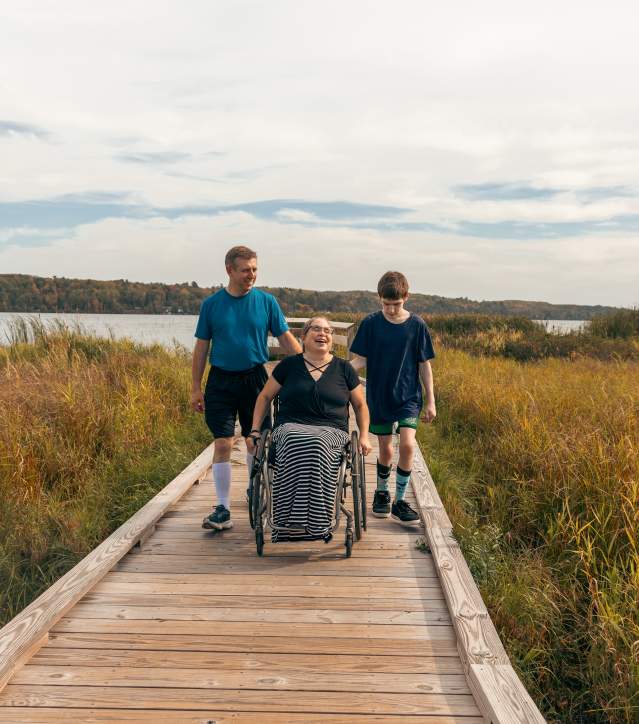 family on accessible boardwalk trail in wetlands