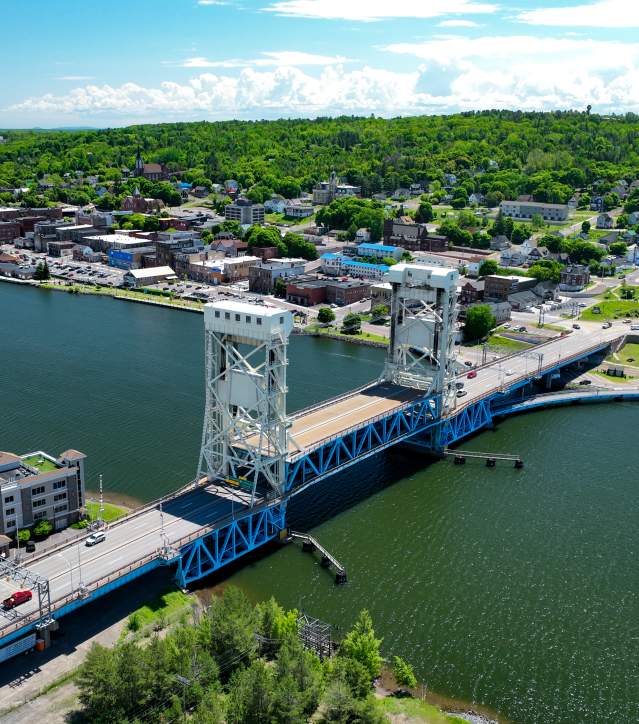 an aerial view of the portage lake lift bridge in the summertime