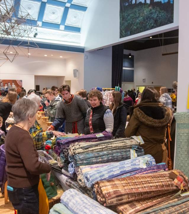 a large open room is full of vendors and people