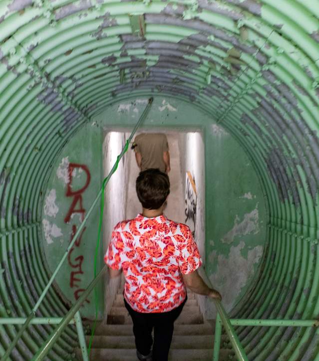 Man goes down into underground bunker at radar base.