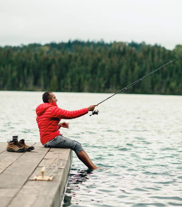 A fisherman casts a line of a dock on Isle Royale.