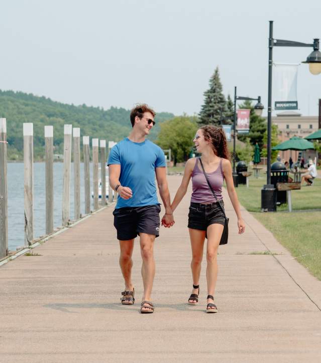 A couple walks along the waterfront trail in Houghton
