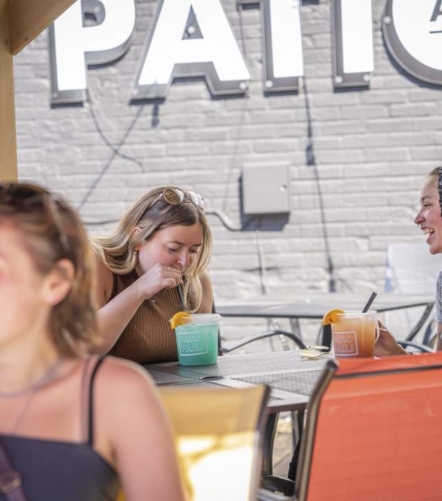 Girls sitting at Gino's patio having a drink.